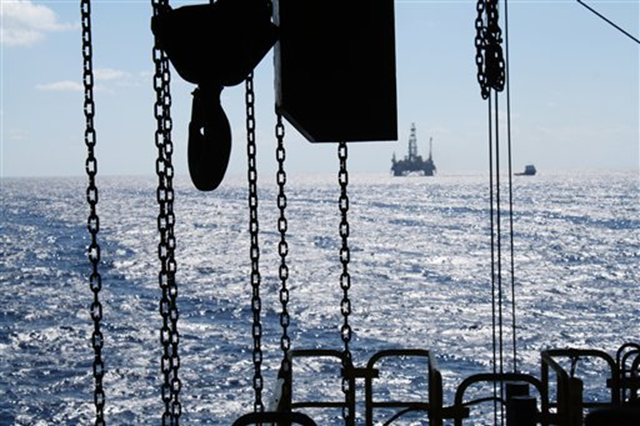 In this 27 October 2011 photo, the satellite oil rig 'Danny Adkins', owned by Noble Oil, can be seen on the horizon from the Perdido platform. Jon Fahey / AP Photo