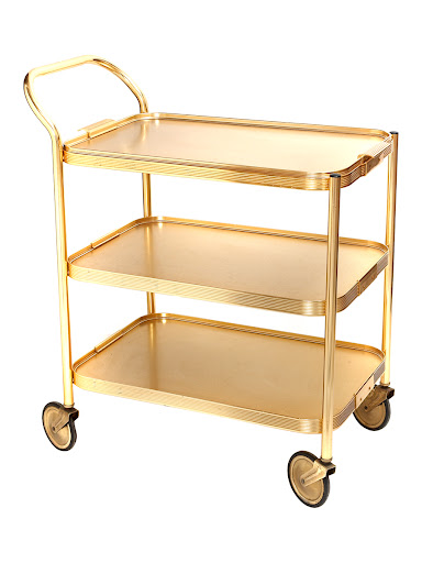 A 70s Gold Trolly to serve desserts on; or set-up a mini cocktail bar on the top. (merchantarchive.com) A 70s Gold Trolly to serve desserts on; or set-up a mini cocktail bar on the top. (merchantarchive.com)
