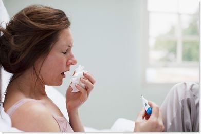 woman sick in bed flu cold