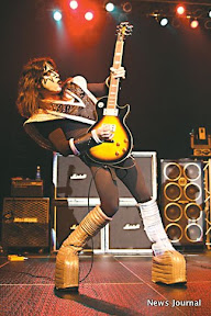 Kriss raises guitar 2x.jpg