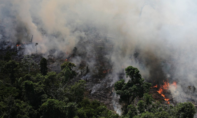 Smoke billows as an area of the Amazon rainforest is burned to clear land for agriculture near Novo Progresso, Para State. The Amazon rainforest has degraded to the point where it is losing its ability to benignly regulate weather systems, according to a stark new warning from Antonio Nobre, one of Brazil&rsquo;s leading scientists. Photo: Nacho Doce / Reuters