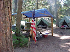A typical campsite. Each has canvas tents on wooden platforms, dining shelters with picnic tables, washstand with running water, outhouse, and fire rings.