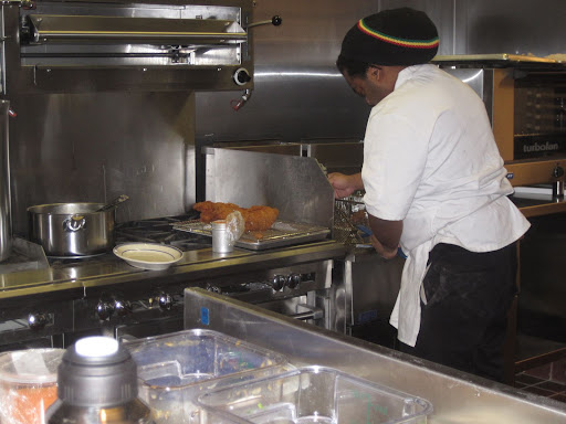 Michael Garrett, a member of Marcus' kitchen staff, helped Marcus with preparations for his chicken.