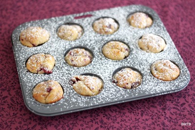 Raspberry and Vanilla Mini muffins in tray with icing sugar dust