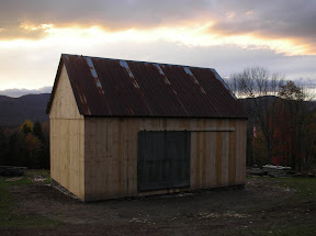The door was found inside of the barn laying across the middle girts above the stanchion.