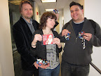 Scott and Steve display their bows, and Maura holds another crafty holiday gift: a mix CD of Christmas tunes.  Scott makes one every year for his friends, never repeating a song!