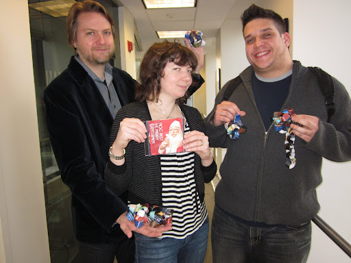 Scott and Steve display their bows, and Maura holds another crafty holiday gift: a mix CD of Christmas tunes.  Scott makes one every year for his friends, never repeating a song!