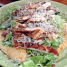 Parmesan Pizza Crust filled with Emeril's Kicked Up Chicken Caesar Salad