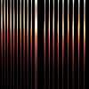 Black metal fence reflecting traffic at night