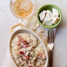 Beer and artichoke risotto with crumbled goat cheese and cured ham
