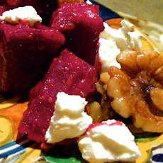 Roasted beets with spicy glaze, toasted walnuts, goat cheese, and candy shallots.