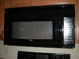 All sleek, black, Whirlpool appliances.