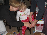 How many adults does it take to put a toddler's shoes on? :)