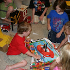 Jonah was taken with the coolness of his loot. The adults were taken with Linus and Aiden's adeptness at assembling toys in the background.
