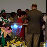 Pastor John and Han praying over Roger's family