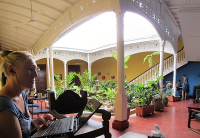 Hails skyping her mom. Panorama shot hence it all looking a bit distorted, but it shows the typical style of the buildings here with courtyards and verandahs surrounding them. IMG_2440-IMG_2445.jpg
