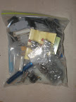 Bag of connectors, flashlight, buttons, etc.