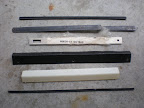 Misc metal brackets, molding, trim and etc. items.  I think the top bracket is the bottom one for a Nintendo bezel.