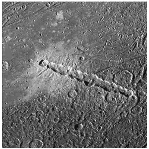 Galileo spacecraft image of Ganymede showing a line of 13 closely spaced craters. A fragmented comet similar to Comet Shoemaker-Levy 9 probably caused this feature.