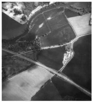 Aerial photograph of a collection of farm buildings.