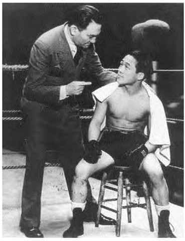 Korean boxer Joe Teiken gets advice from his manager Frank Tabor during a fight in California, 1933. 