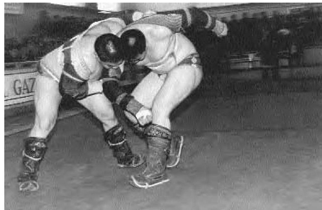 Two Outer Mongolian wrestlers in the middle of a tournament. 