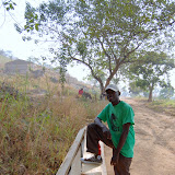  &ndash; James with building materials, school in background, February 12, 2008....© 2008 NHA photos
