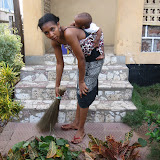  &ndash; Kadijah w/ Roo sweeping front porch (James Mansaray, photographer)
