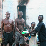  &ndash; Ann Marie from St. Laurence House taking food to survivors from House Fire in Freetown, Dec. 2006 (James Mansaray, photographer)