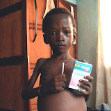 &ndash; Sheku with worm medications sent from Nazareth House. Unfortunately it was too little too late. Sheku passed Feb. 2007 (James Mansaray, photographer)