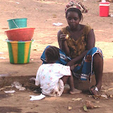  &ndash; Lady finishing off her mango before sharing with child. May 2007 (James Mansaray, photographer)