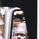  &ndash; Children peering through vehicle window (James B. Mansaray, photographer)