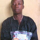  &ndash; Tamba Gaugah, victim of RUF. His amputation was considered "long sleeve" hacking of his arms. Here he holds bag of medicine provided by Nazareth House (Photo property of NHA, James Mansaray, June 2007)