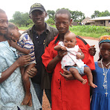 &ndash; The "smiling man" in blue with James and other members of his village. © NHA, J Mansaray 2007