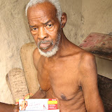 &ndash; Man with severe arthritis. James gives him some muscle rub for the pains. © NHA, J Mansaray 2007
