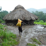  &ndash; man of the village carrying the rice back to his hut in the rain.......© 2007 NHA photos