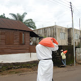  &ndash; Father follows James with second bag of rice.....© 2008 NHA photos