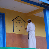  &ndash; Fr. Seraphim paints NHA Logo/Trade Mark on the Kabala School Building...© 2008 September Nazareth House Apostolate Media, James B. Mansaray, photographer.