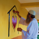  &ndash; Fr. Seraphim paints NHA Logo/Trade Mark on the Kabala School Building...© 2008 September Nazareth House Apostolate Media, James B. Mansaray, photographer.