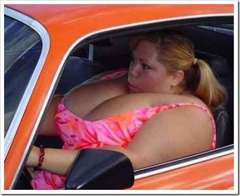 Funny photo weight - Woman with huge breasts inside car.