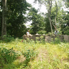 Owen is outside the cemetery wall with his small tractor mow and George is inside with a weedeater.
