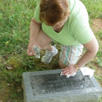 Joyce Ann Blanchard, sister of George Wilkerson cleans a tombstone with baby oil.