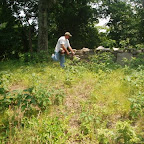 George weed eats outside wall where Micheal Gleaves is buried.
