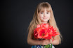 Little Girl Holding Flower on grey background
