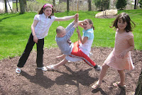 Lucy, Michael and Molly playing on the swing at Moon