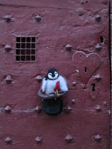 Percy knocks on the M-Js favorite Medieval door.  See how it suits him?  -- Look closely.