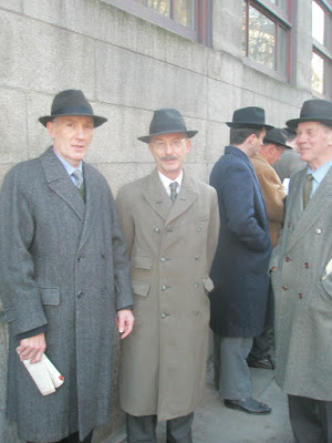 three older gentlemen dressed in 1930s attire face camera