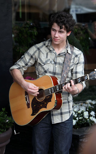 02-02-10 Sherman Oaks, CA  Nick Jonas performed a solo show for his fans outside of Mark's Garden flower shop in Sherman Oaks. After the show, he handed out roses to all the girls in attendance. Like a typical teenager, Nick has a few zits on his face.  NON-EXCLUSIVE PIX by Flynet ©2010 818-307-4813  Nicolas