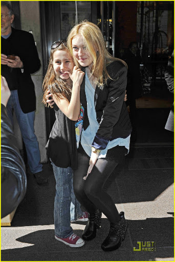 38650, NEW YORK, NEW YORK - Tuesday March 16, 2010. Dakota Fanning stops to pose with her young fans as she steps out of her NYC hotel wearing a lacy skirt with stockings and a black blazer. The 16 year old actress is currently promoting her latest flick "The Runaways" with co-star Kristin Stewart. Photograph: PacificCoastNews.com**FEE MUST BE AGREED PRIOR TO USAGE** **E-TABLET/IPAD & MOBILE PHONE APP PUBLISHING REQUIRES ADDITIONAL FEES** UK OFFICE:+44 131 557 7760/7761 US OFFICE:1 310 261 9676