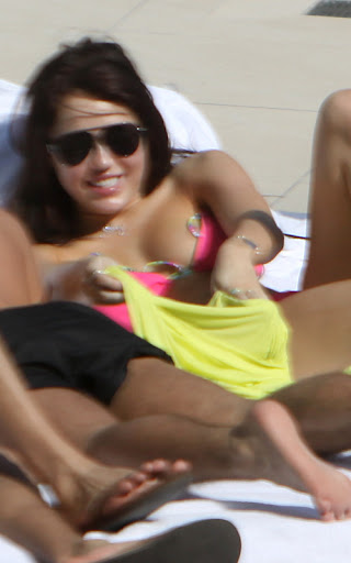 December 3, 2009: Miley Cyrus pictured sunbathing by the pool in Miami, Florida. Credit: INFphoto.com Ref.: infusmi-11/13